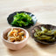 An assortment of Asian side dishes served in Japanese-style ceramic plates